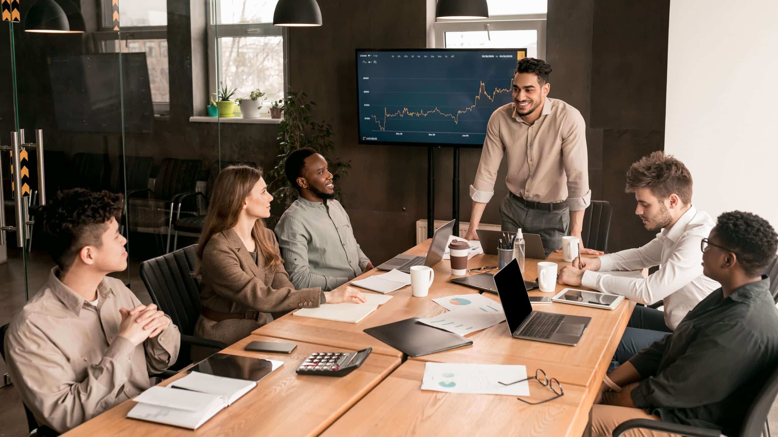 Colleagues having meeting in board room, businessman giving speech