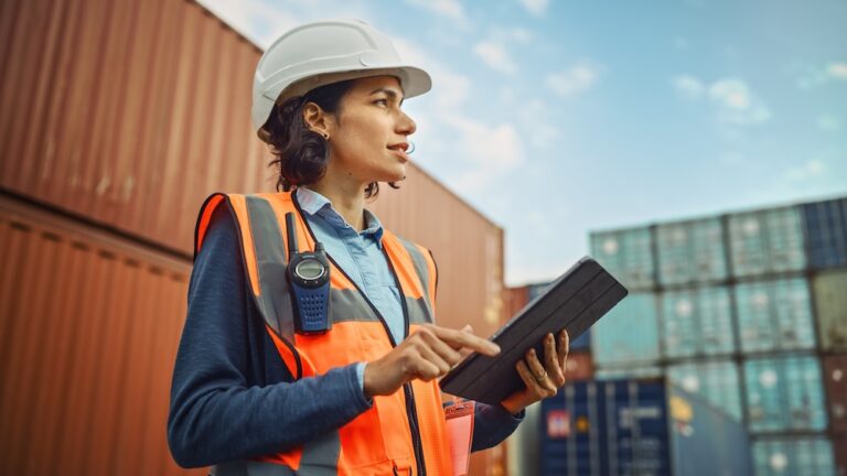 Latin Female Industrial Engineer in White Hard Hat wearing a High-Visibility Vest