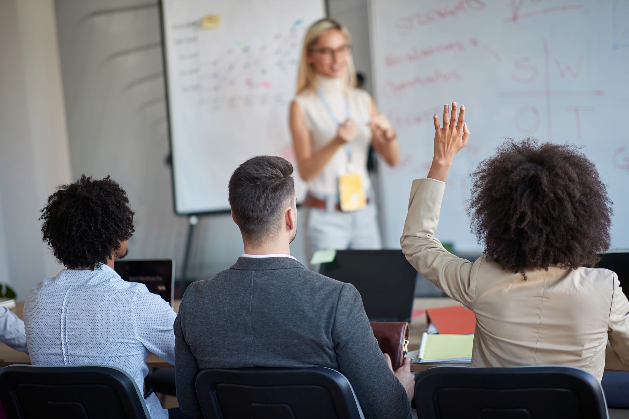 young blonde female manager teaching colleagues.