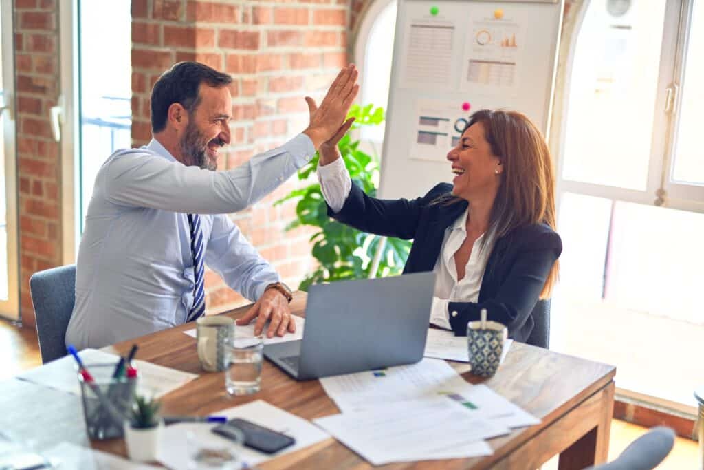 A picture of Employees High Fiving each other