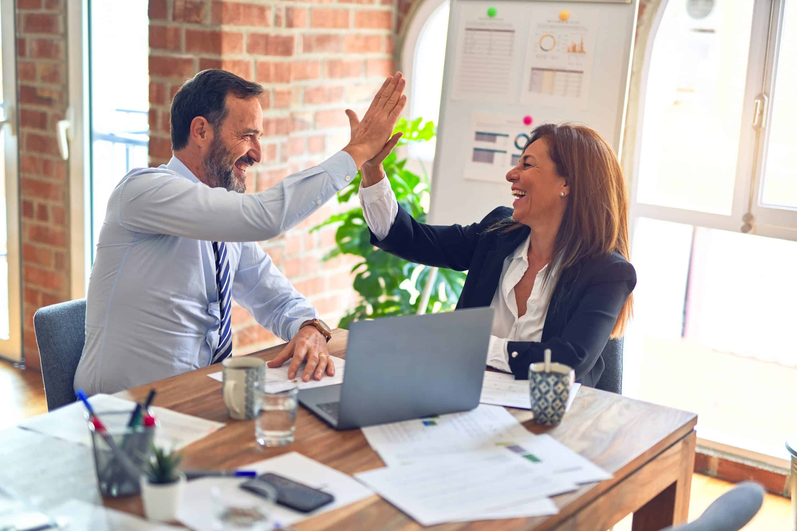 A picture of Employees High Fiving each other